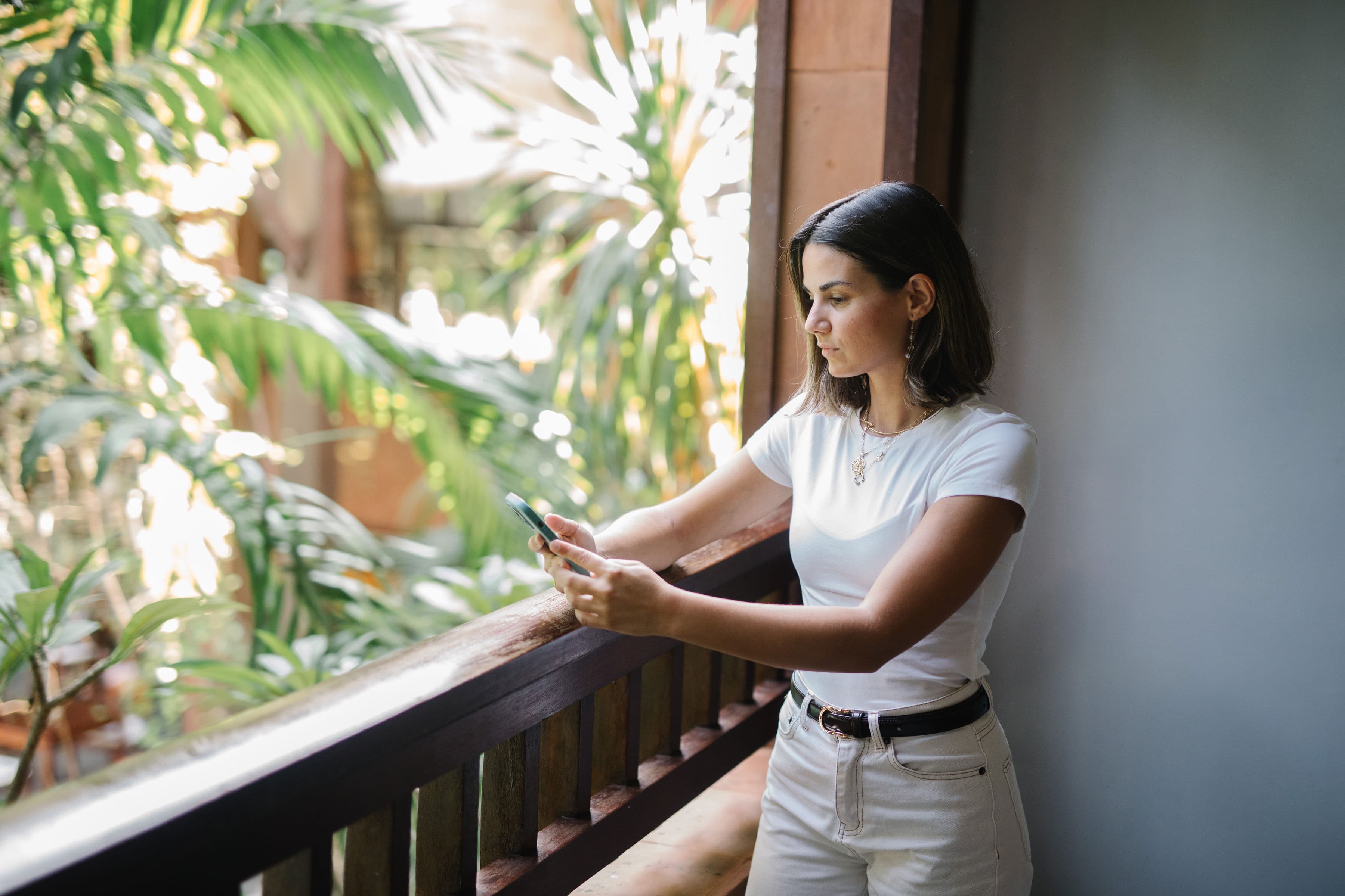 Anna Espina working from a tropical balcony